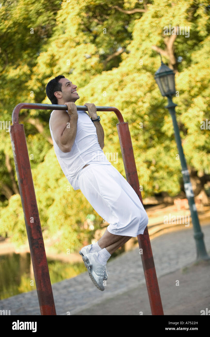 Man doing pullups outdoors Stock Photo Alamy