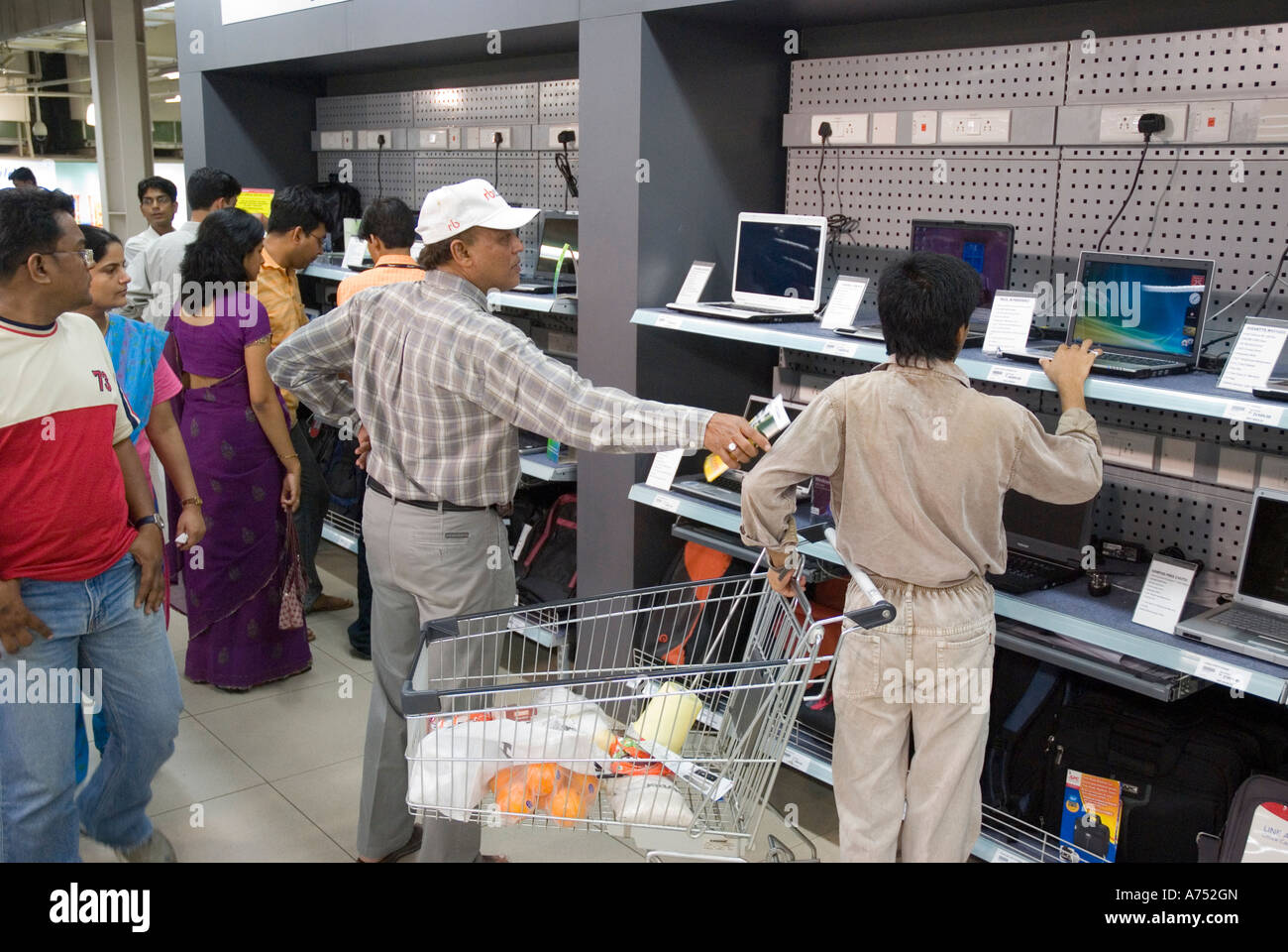 Customers looking at laptop computers in a supermarket in India Stock Photo Alamy
