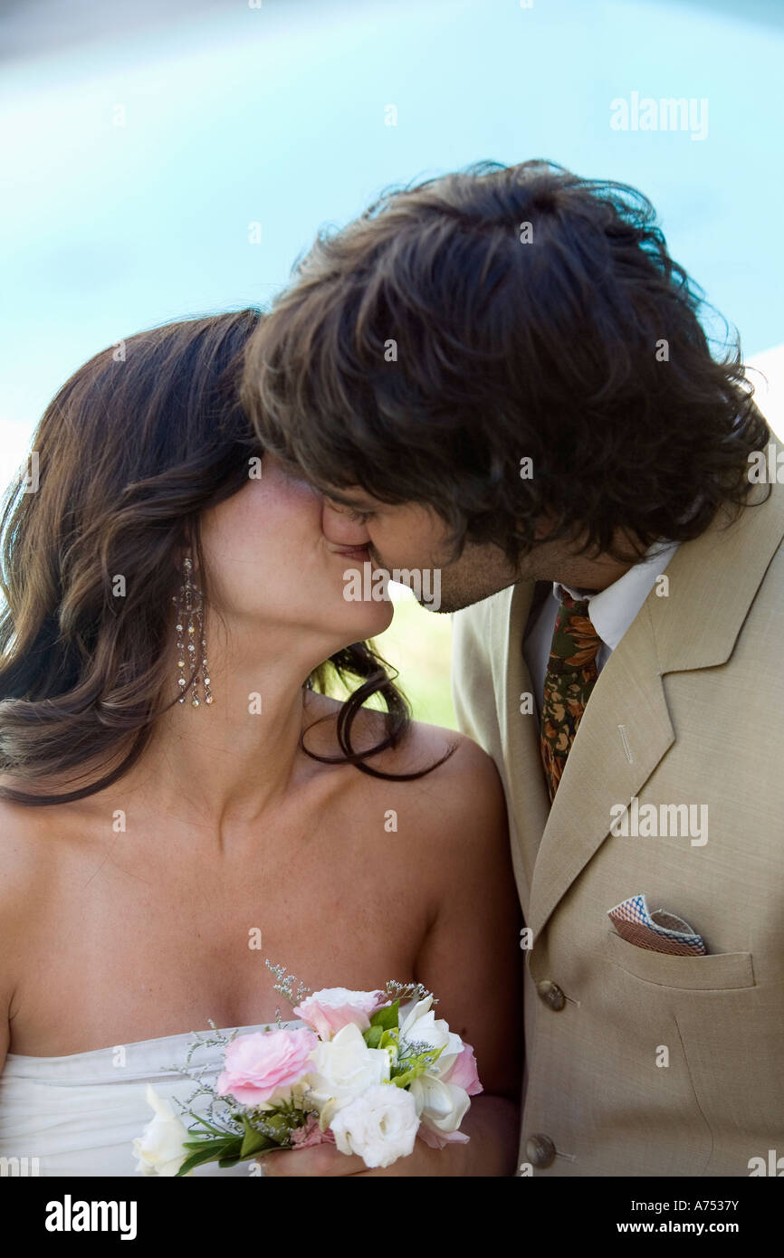 Newlywed couple kissing Stock Photo - Alamy