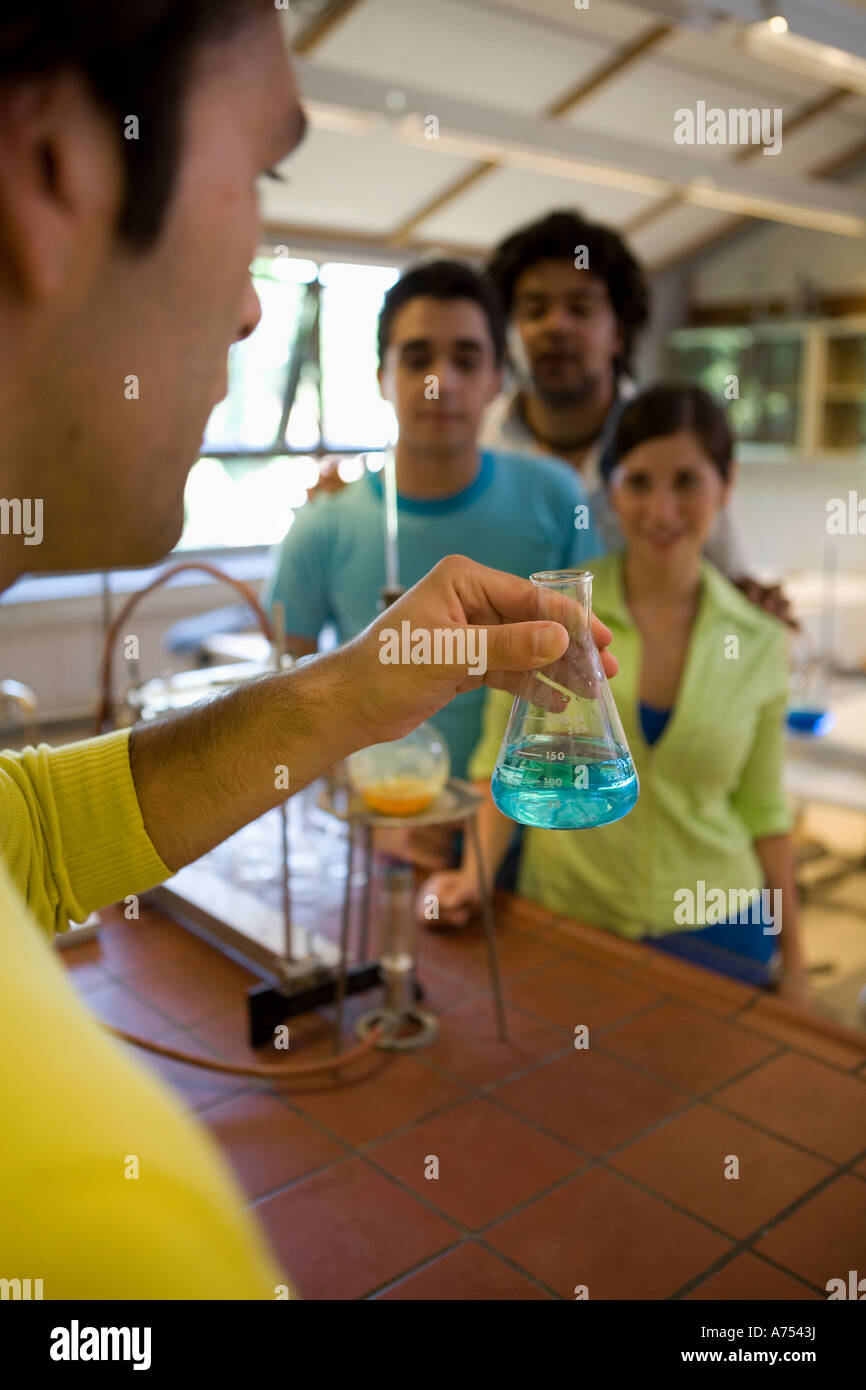 Science teacher demonstrating to students Stock Photo
