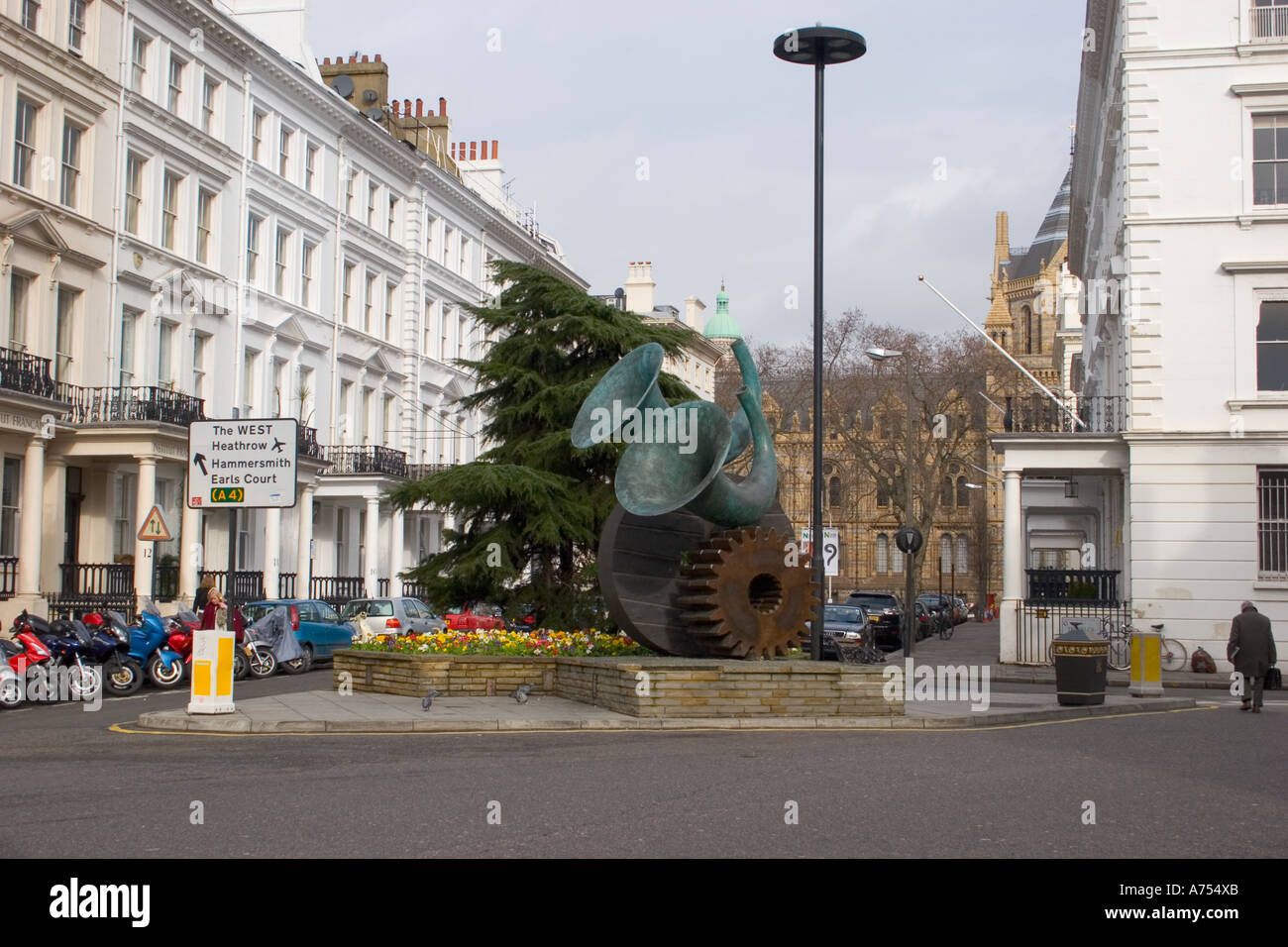 A sculpture of two musical horns on top of two mechanical cogs in Kensington London Stock Photo