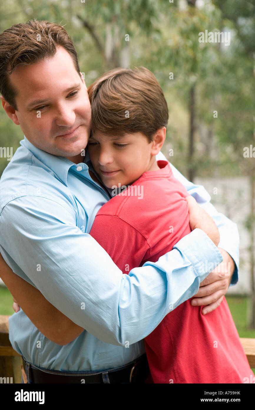 Young man hugging his son Stock Photo