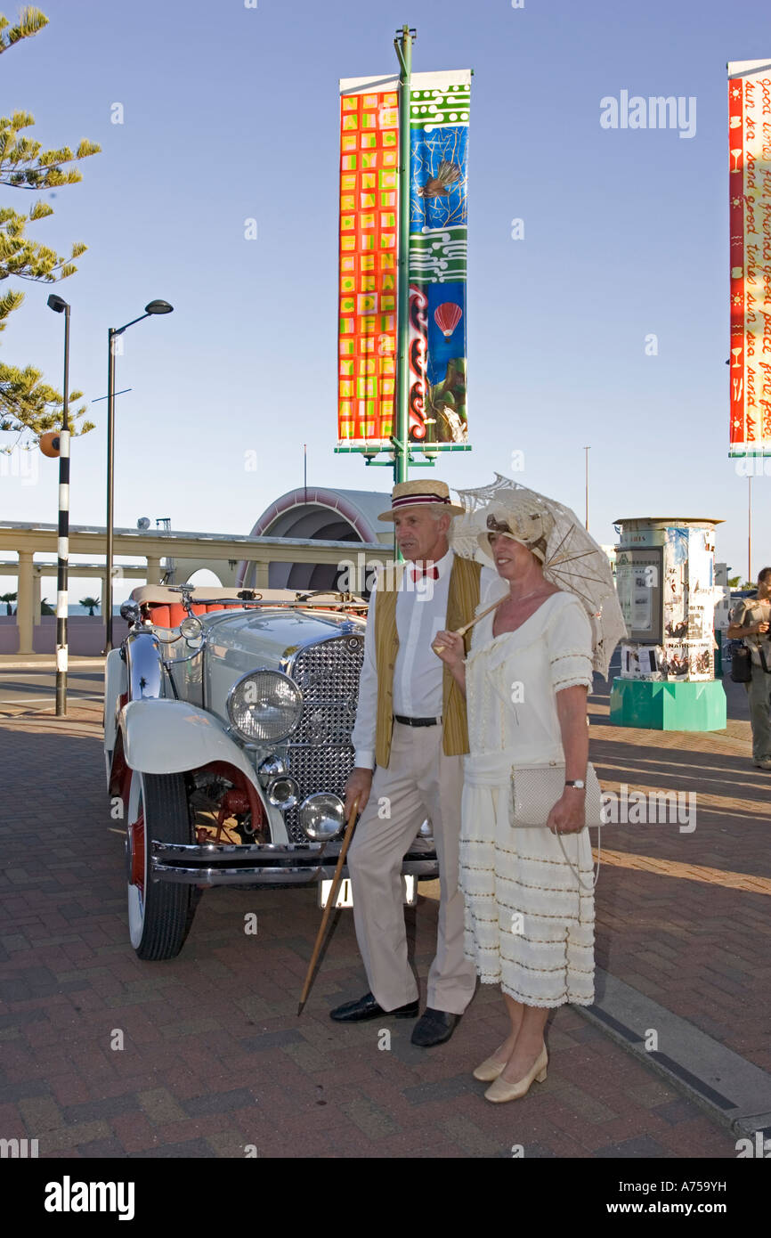 Man woman in 1930s dress by vintage classic 1930 Studebaker convertible car Art Deco weekend Napier North Island New Zealand Stock Photo