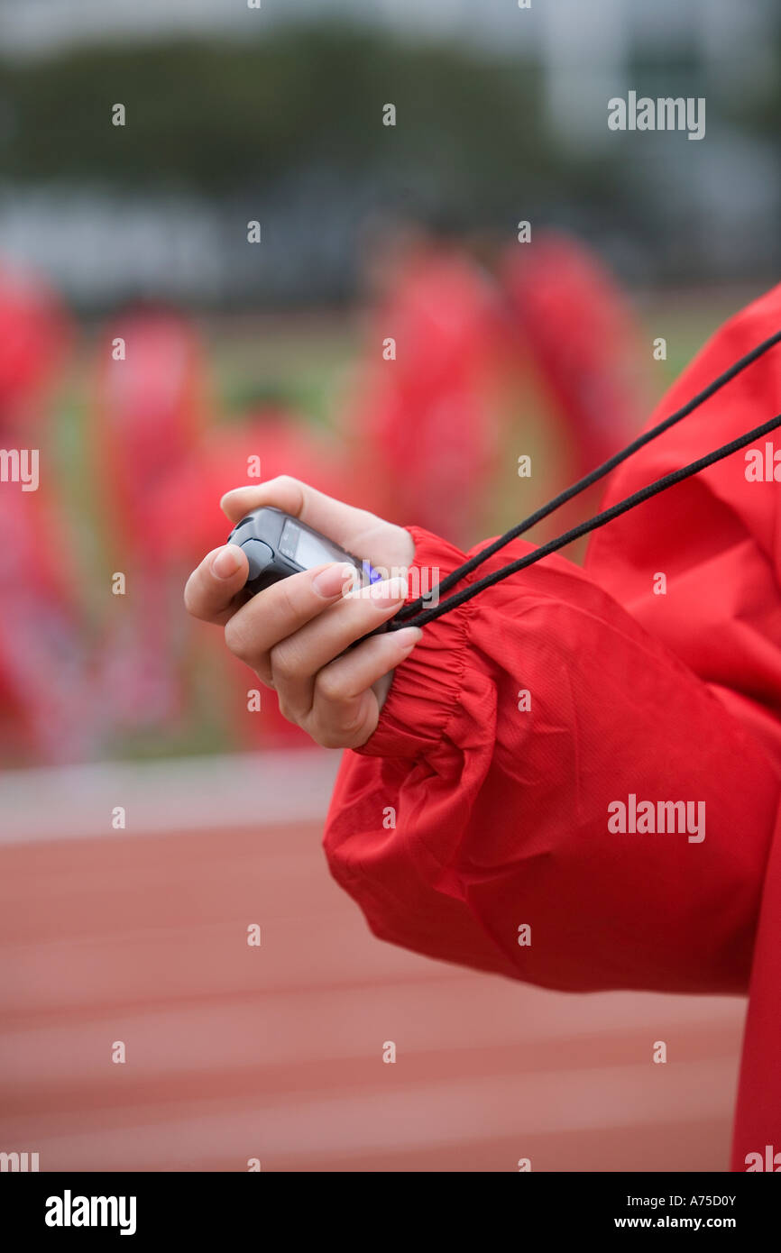 Athletic coach using stopwatch Stock Photo Alamy