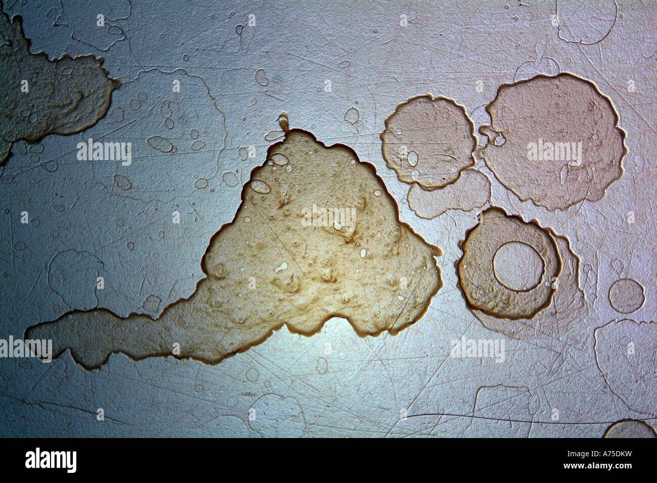 embossed metallic stains with scratches form a background texture Stock Photo