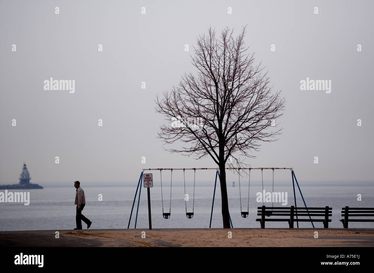 Winter Beach scenic with man walking New Haven Connecticut USA Stock Photo