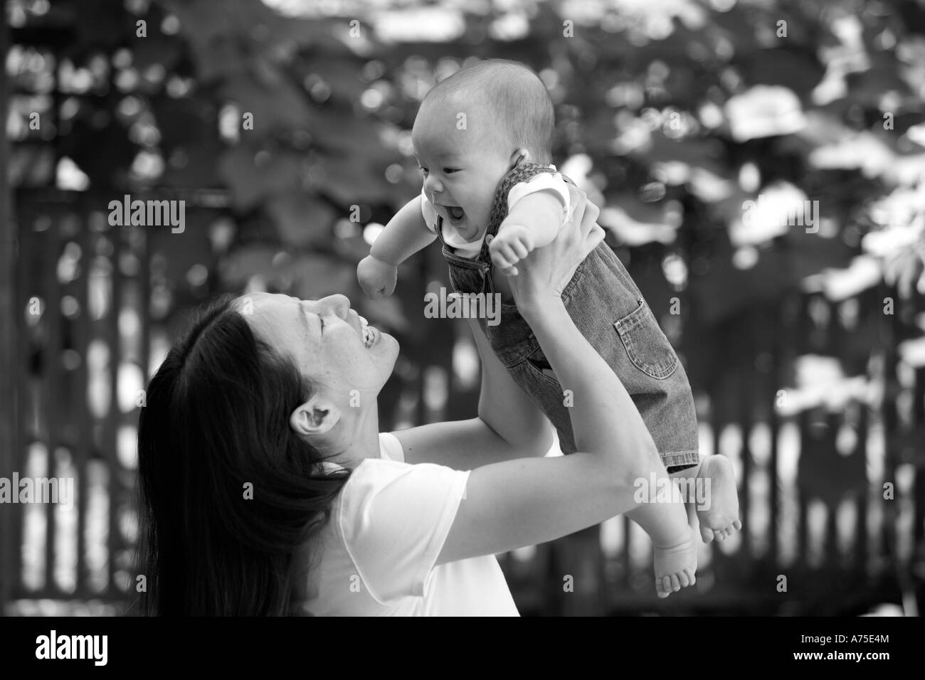Mother and Baby smiling and interacting playing outside Stock Photo
