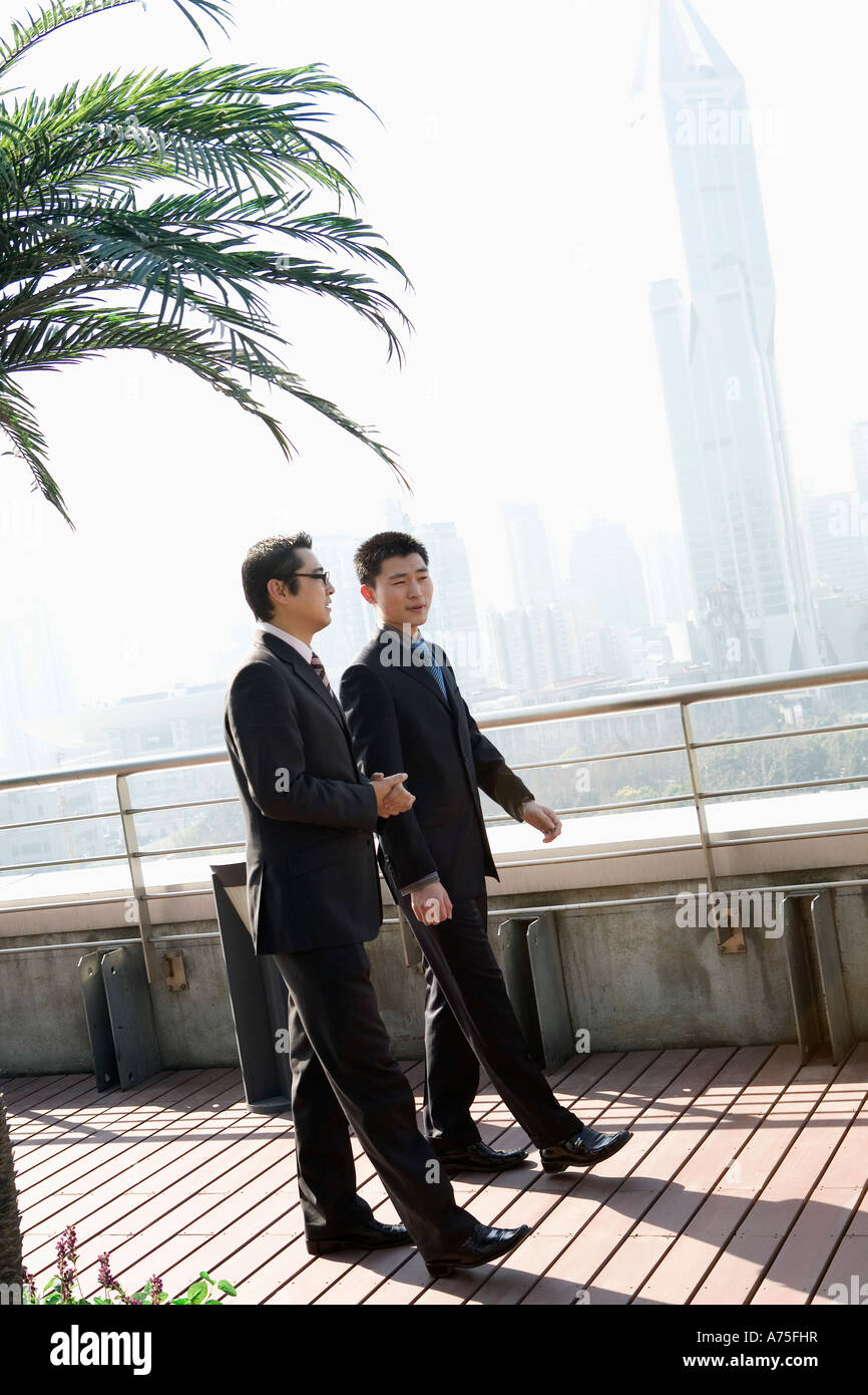 Businessmen walking outdoors Stock Photo - Alamy