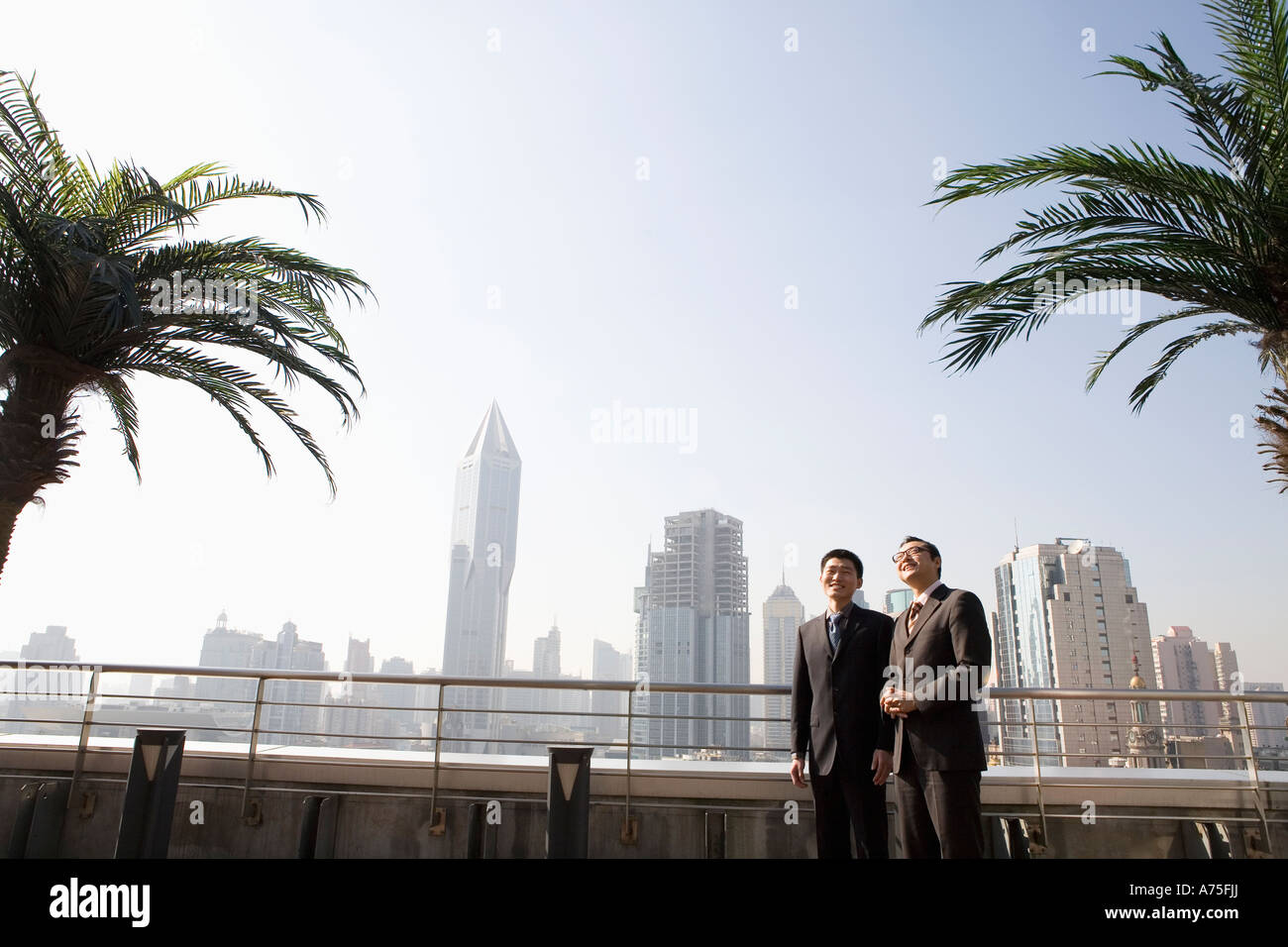 Businessmen walking outdoors Stock Photo - Alamy