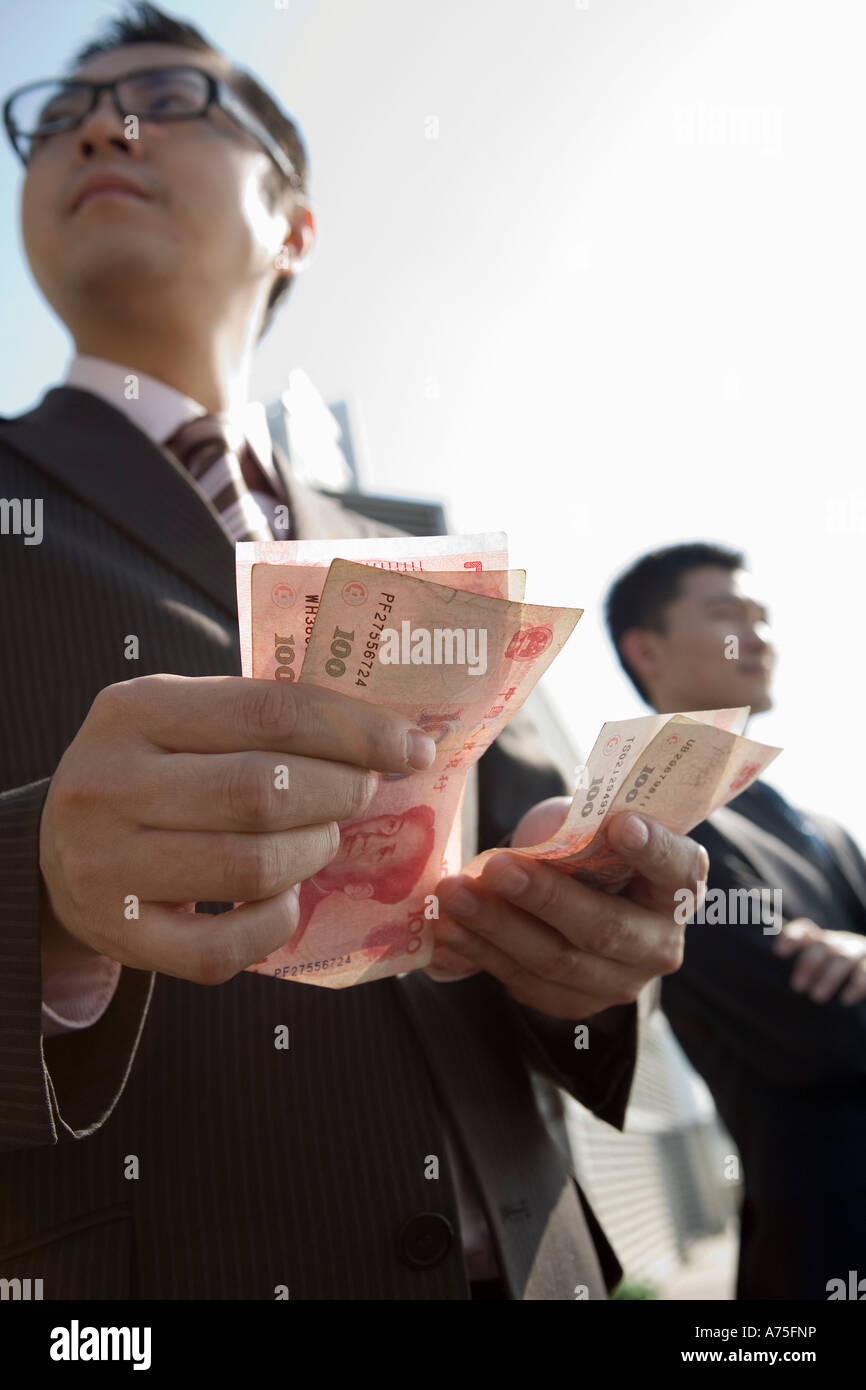 Businessman counting money Stock Photo - Alamy