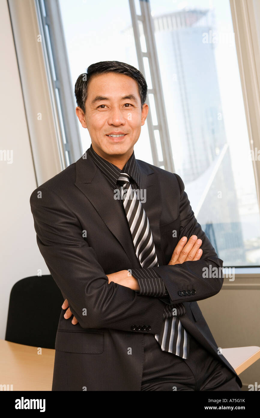 Businessman smiling in office Stock Photo - Alamy