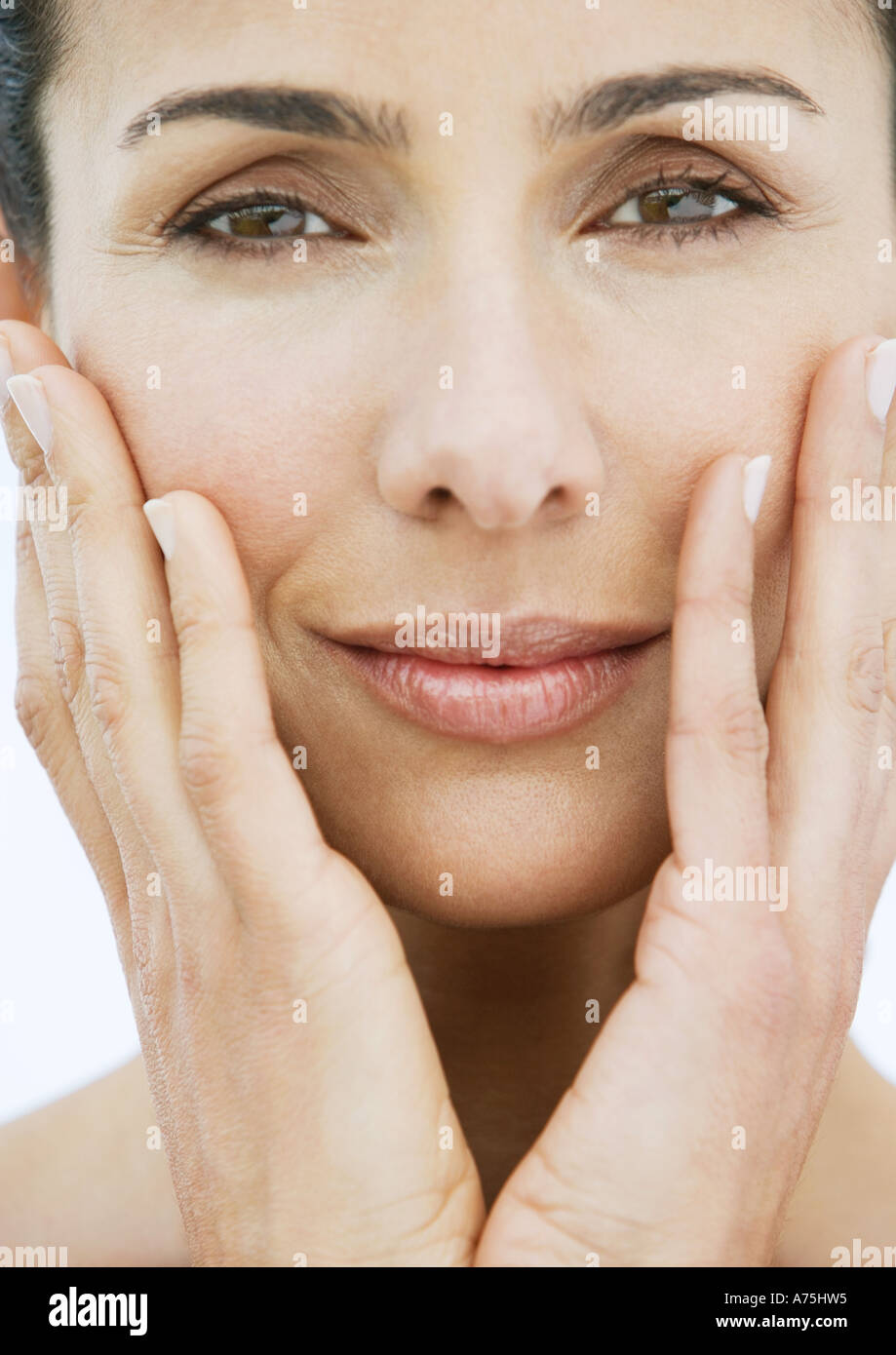 Woman with hands on cheeks Stock Photo