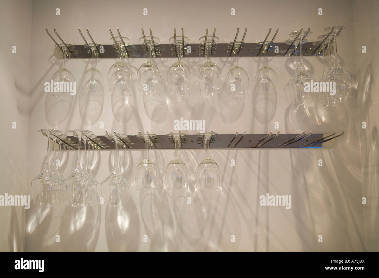 Empty wine glasses on rack Stock Photo - Alamy