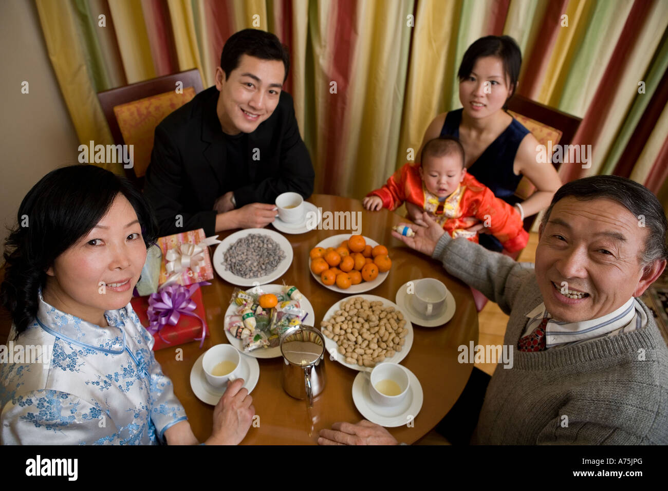 Family eating at dinner table Stock Photo - Alamy