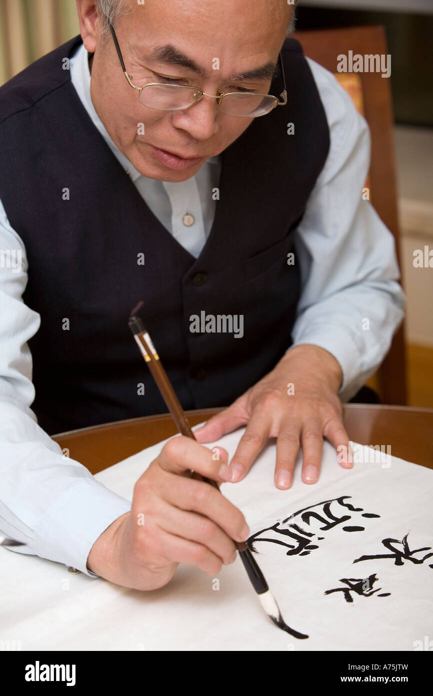 Middle-aged man practicing calligraphy Stock Photo - Alamy