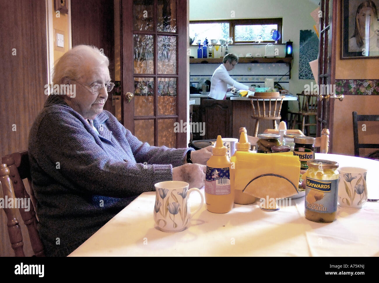 Older woman at meal table Stock Photo