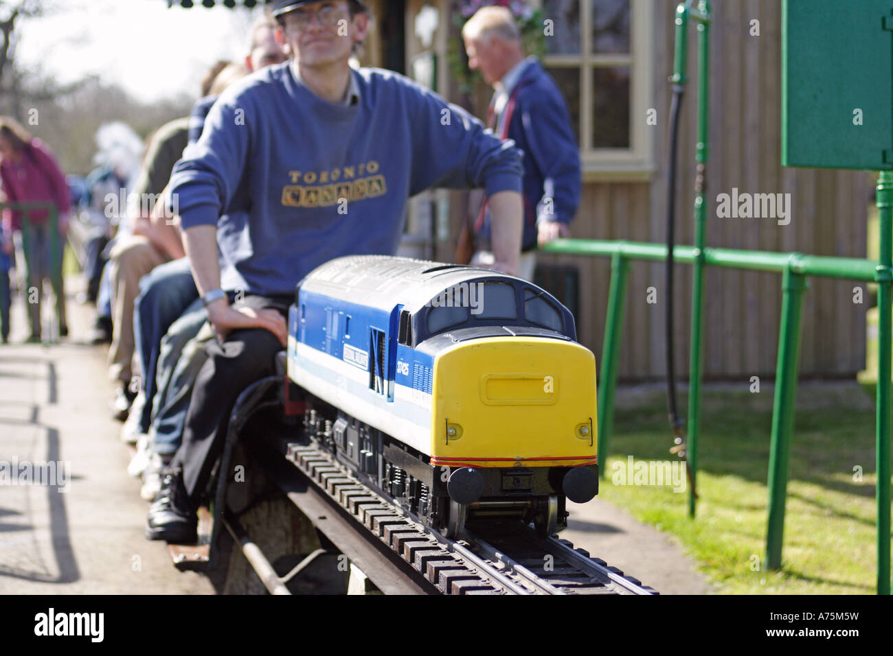 Model sit on electric train with passengers Stock Photo