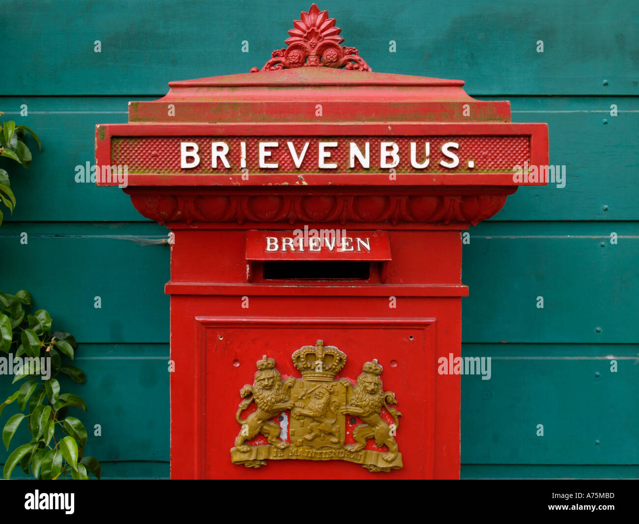 Antique cast iron red Dutch mailbox brievenbus Stock Photo