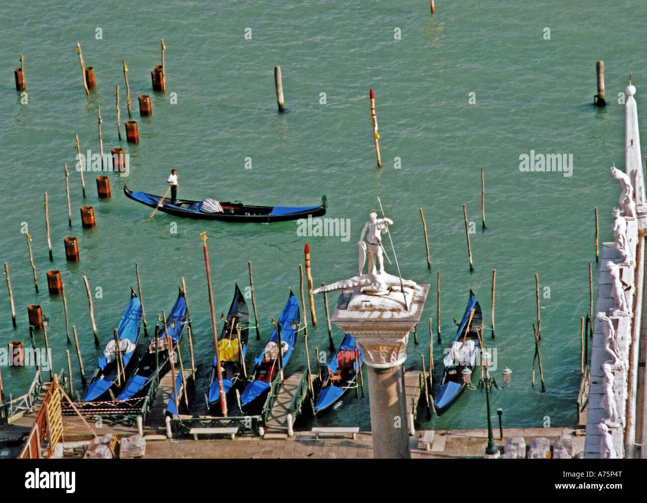 VENICE - gondolas alongside St Mark's Square with the Column of San Teodoro in foreground Stock Photo