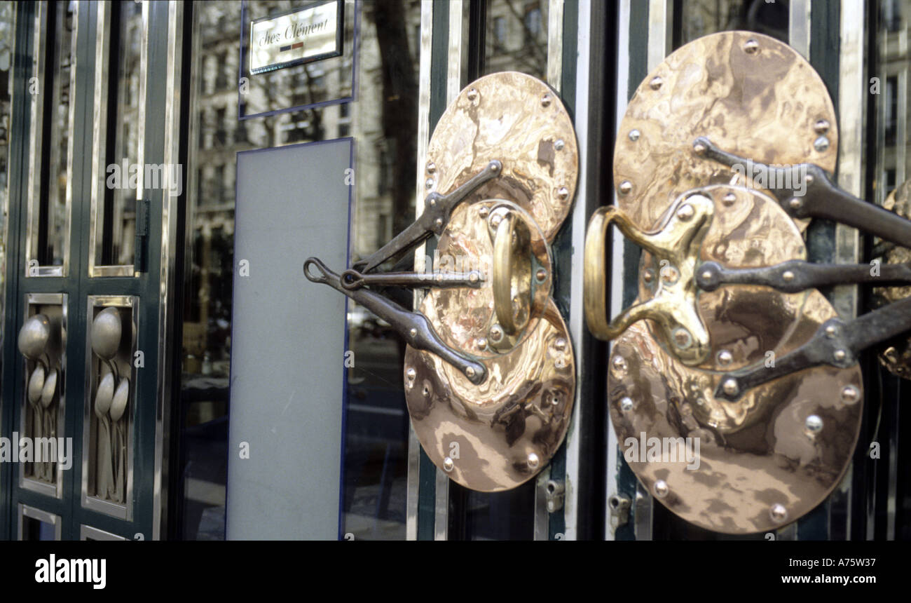 Quirky culinary door handles [saucepans and spoons] outside restaurant