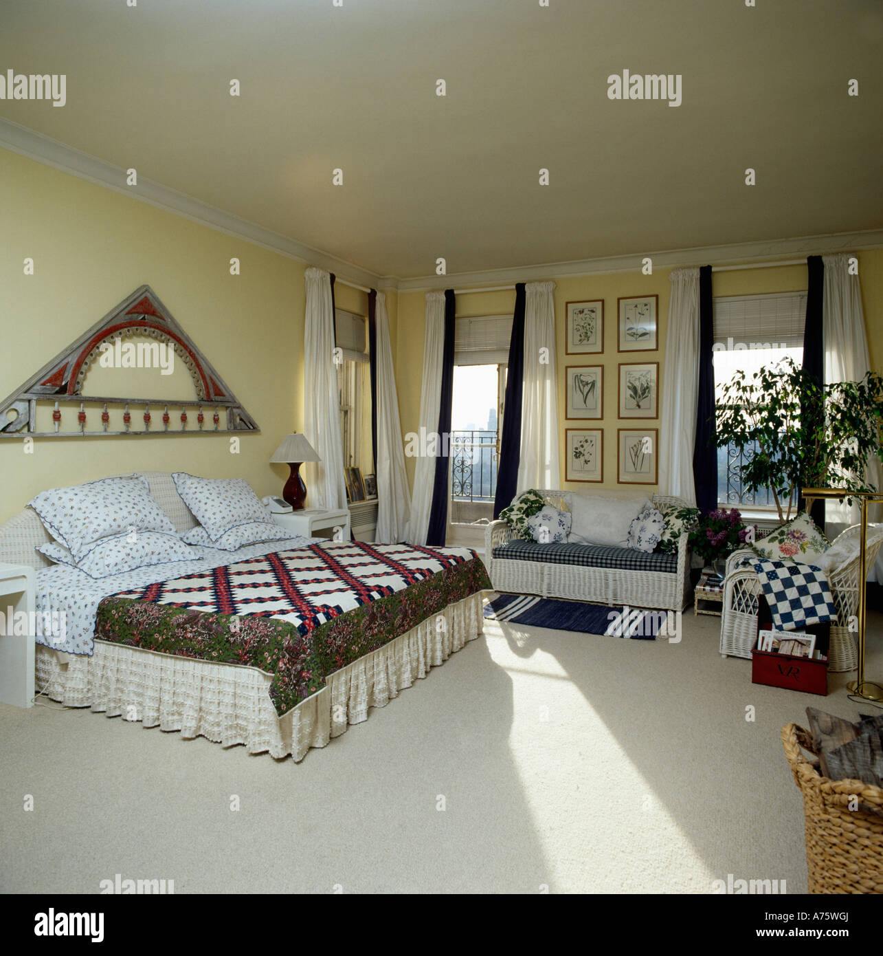 Patchwork Quilt On Bed In City Bedroom With Crea Carpet And Cream