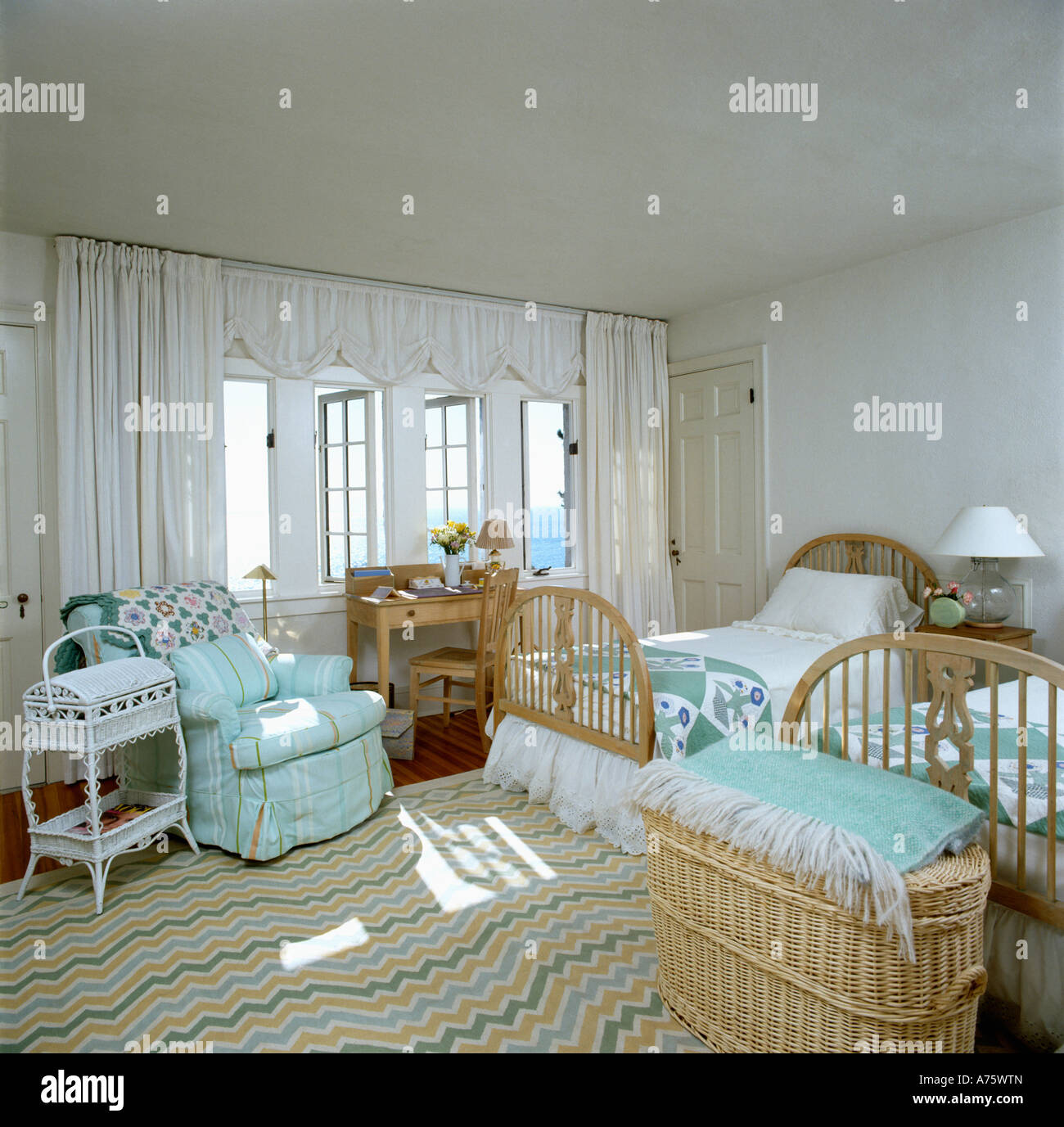 Twin Beds In Seaside Bedroom With Turquoise Armchair And