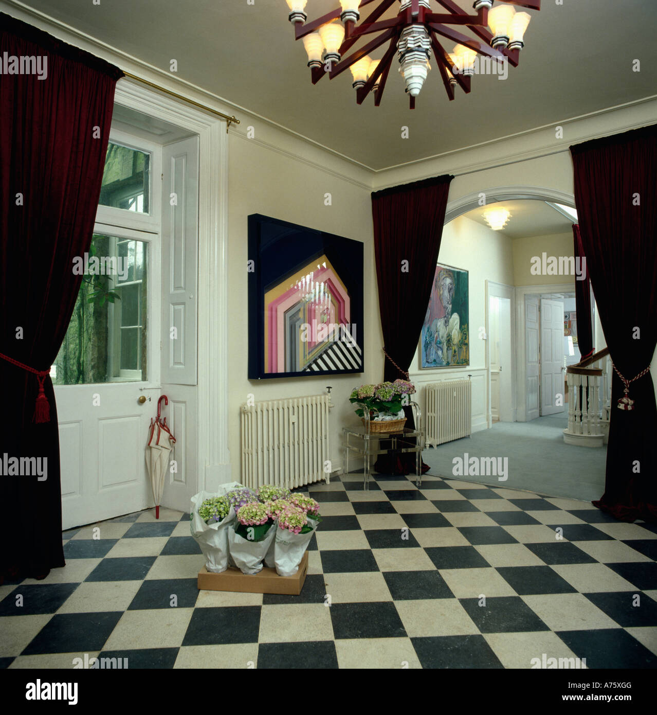 Black and white check floor in eighties hall with black curtains and ...