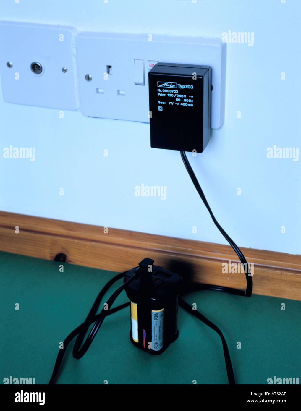 Recharging NiCad batteries from the mains using a small transformer to reduce voltage from 240 to 7 volts, England, UK. Stock Photo