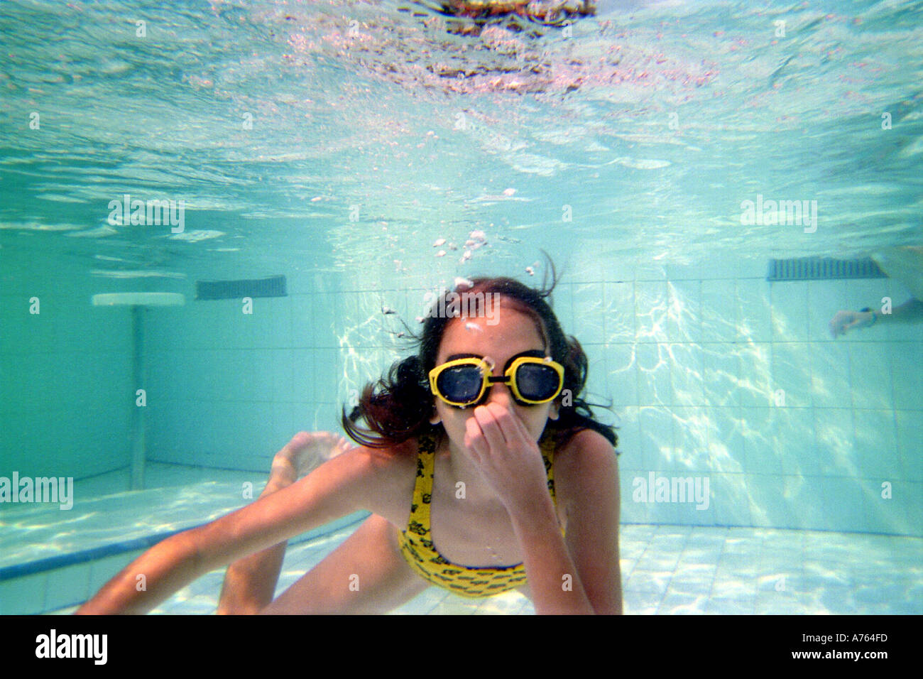 Girl Wearing Goggles and Swimming underwater Stock Photo Alamy