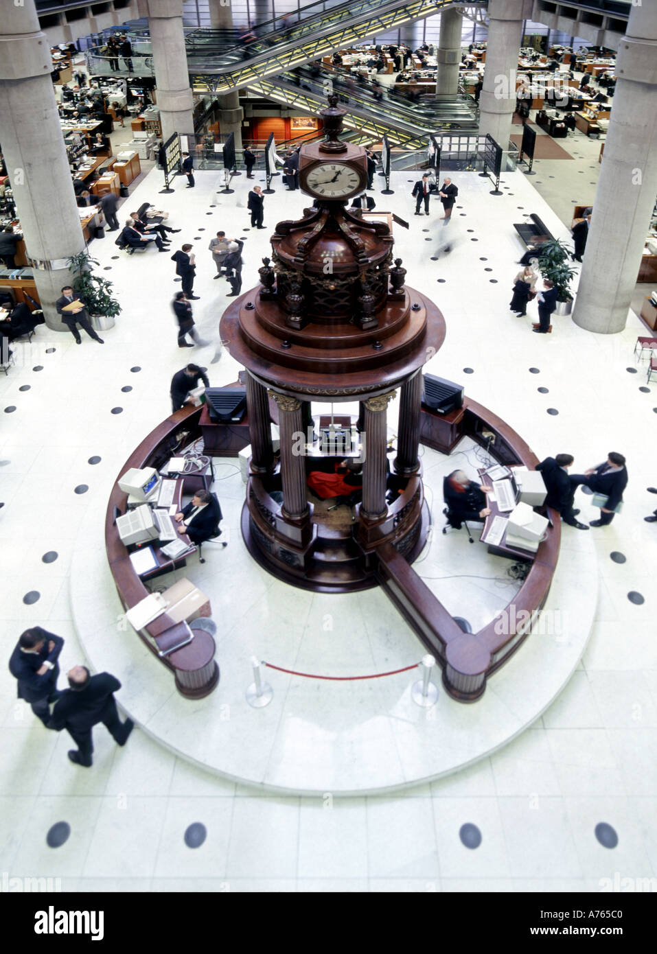 Lloyds of London modern interior business building view from above looking down people clock tower & historical Lutine Bell City of London England UK Stock Photo