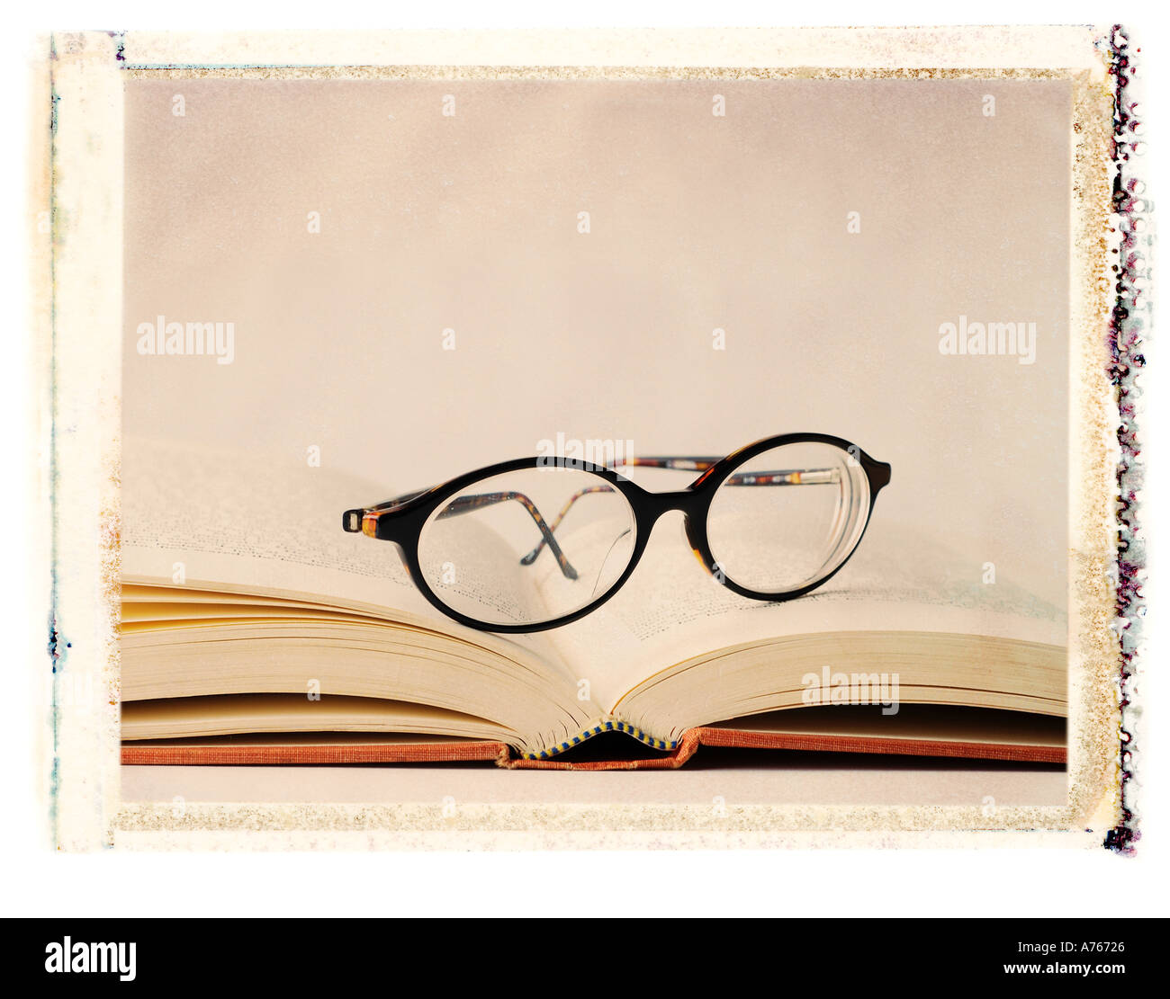 eye glasses sitting on an open book Stock Photo