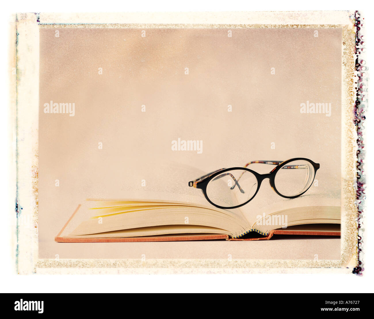 eye glasses sitting on an open book Stock Photo