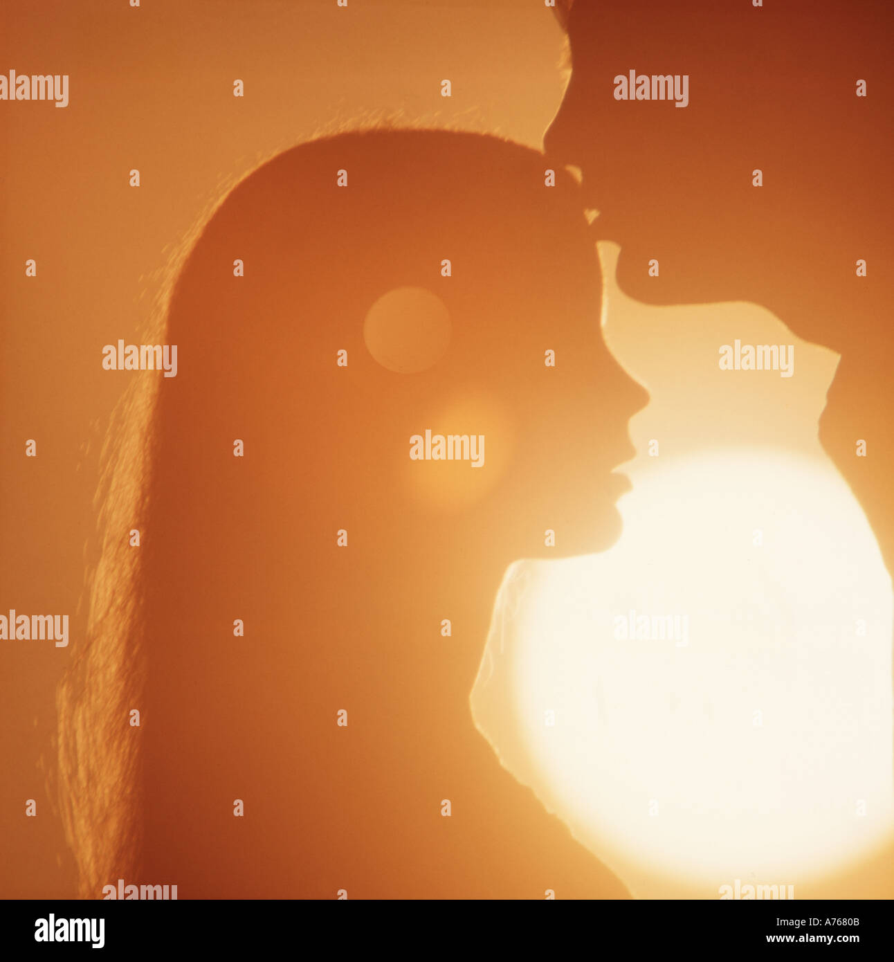 romantic couple embracing at sunset Stock Photo