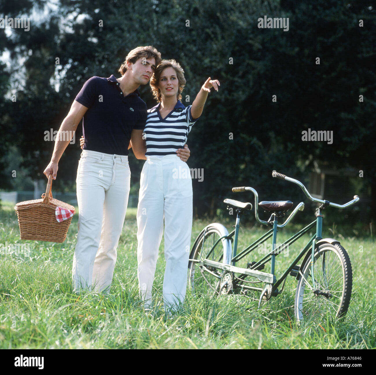 couple with tandem bicycle going on picnic Stock Photo