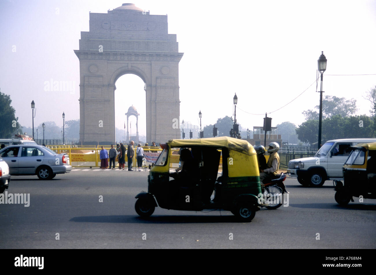 An auto three wheel taxi going past the India Gate Delhi India Stock Photo