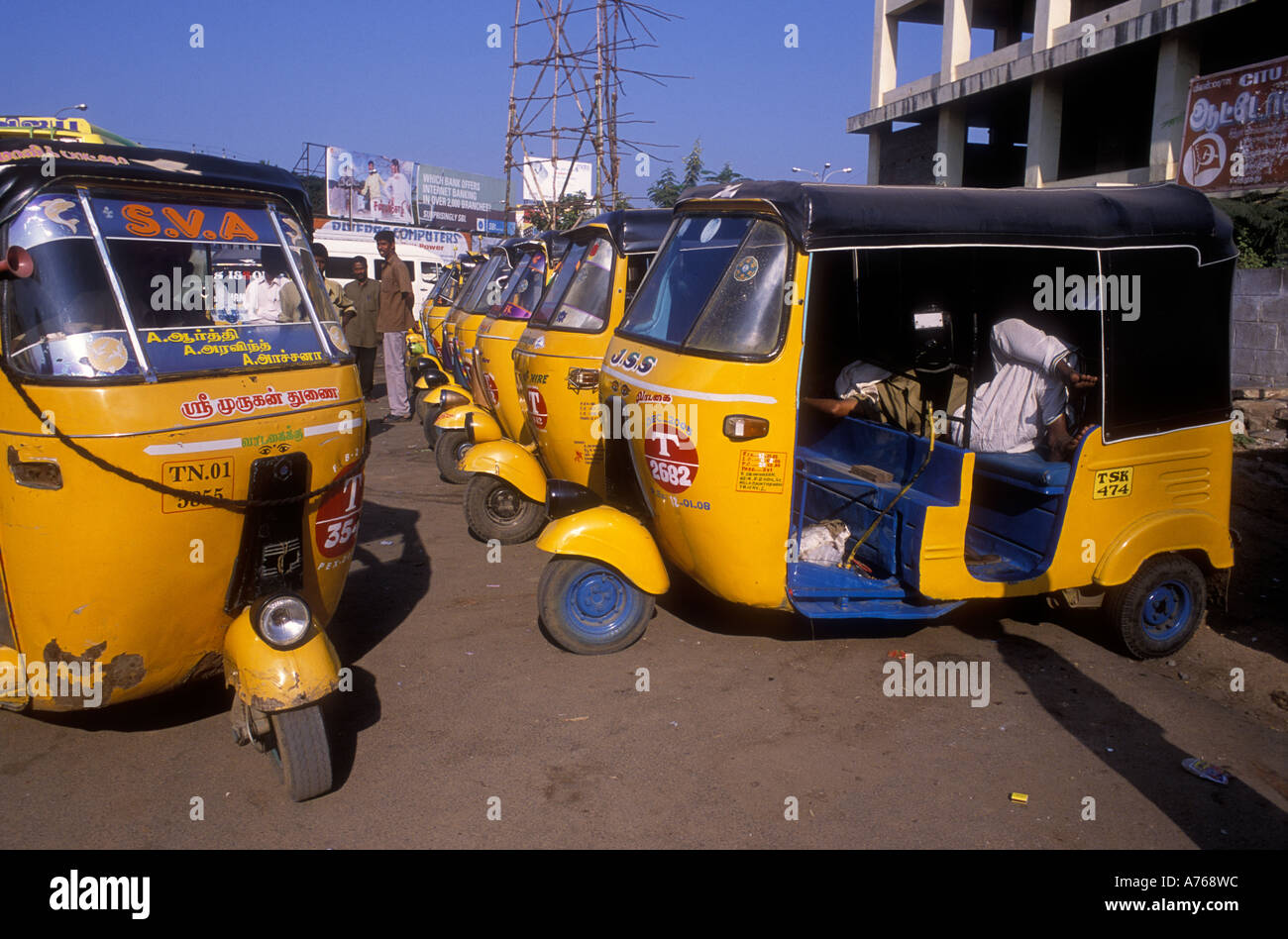 A line of yellow Auto three wheel taxis waiting for fares Tiruchirapalli Tamil Nadu India Stock Photo