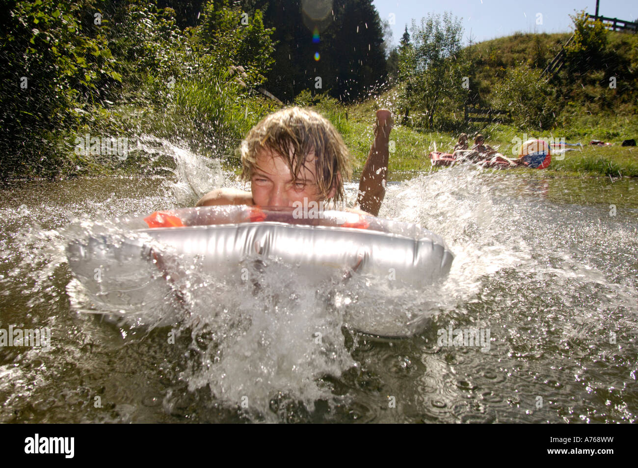 Young man jumping on air mattress Stock Photo Alamy
