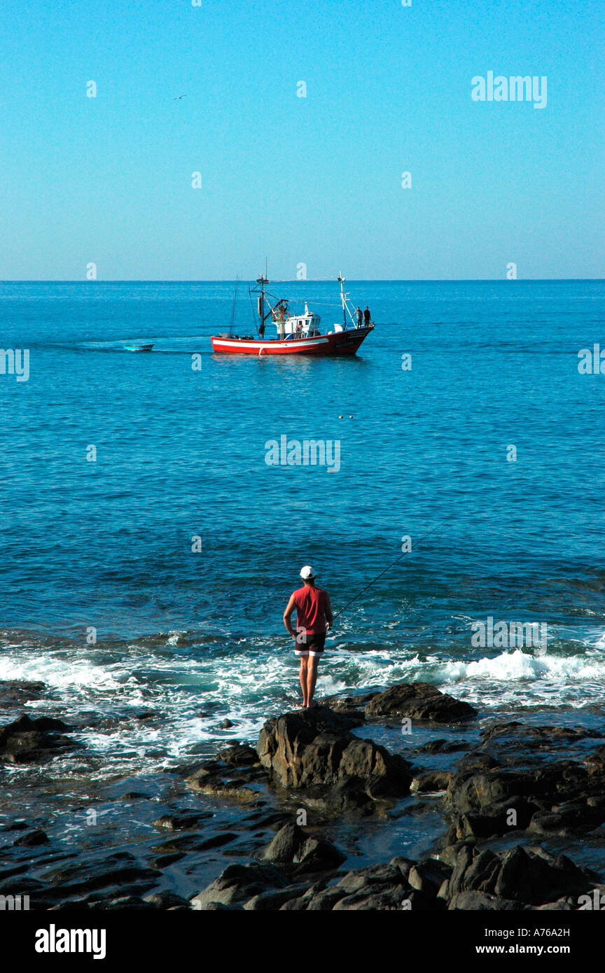Fisherman and ship in Carpinteras Beach GRAN CANARIA Canary Islands Spain Stock Photo