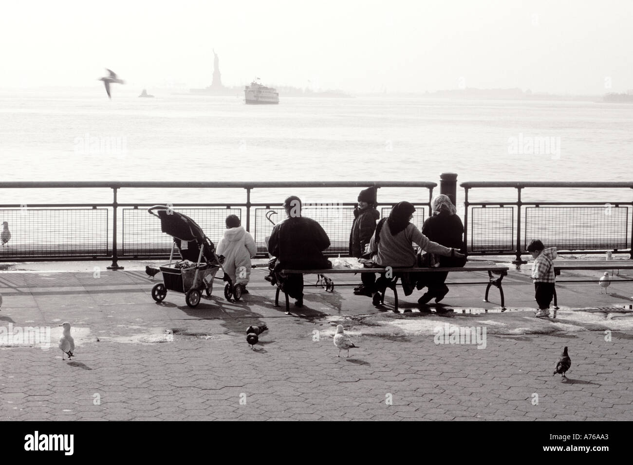 A muslim family in Battery Park looking at the Statue of Liberty New
