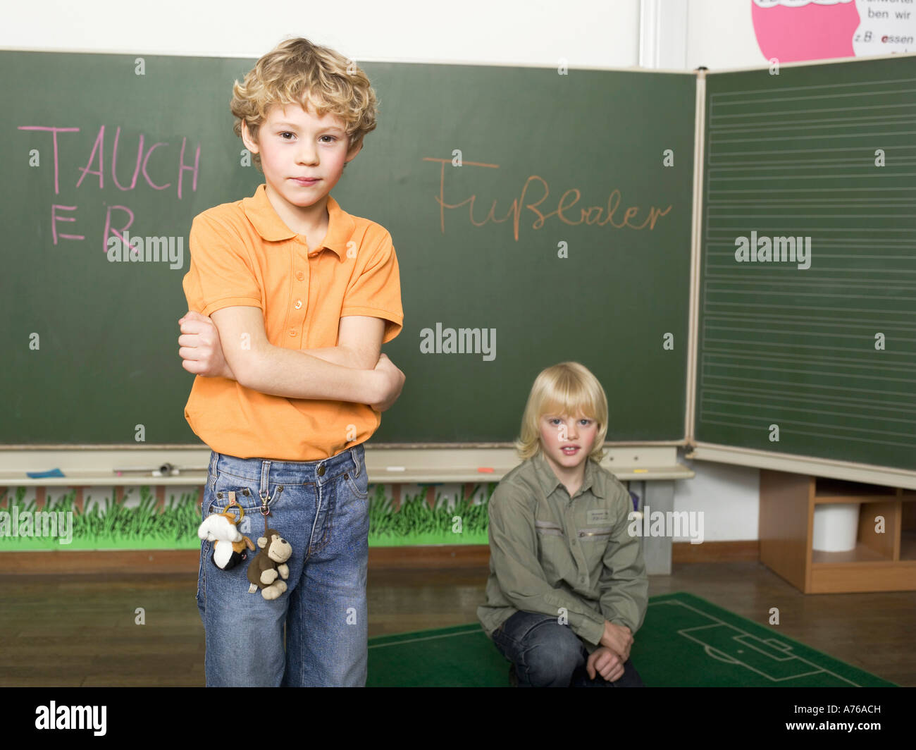Two boys (4-7) in front of blackboard, portrait Stock Photo