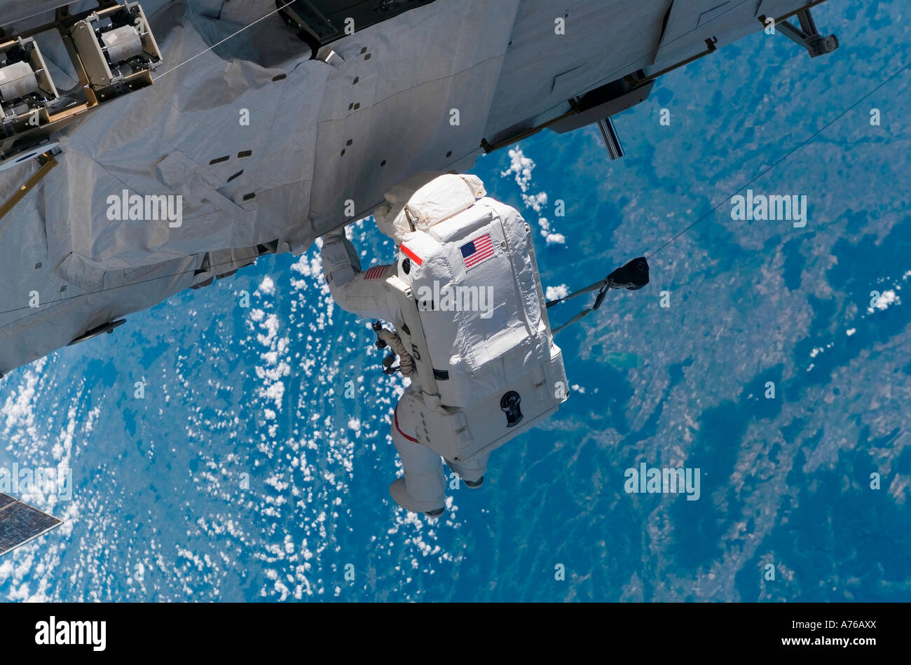 Mission specialist traverses along the station hardware during installation day on the International Space Station. Stock Photo