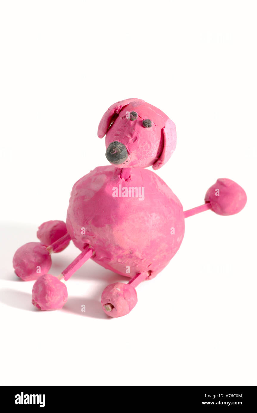 Pink Plasticine dog with matchstick legs: A child's handcrafted creation Stock Photo
