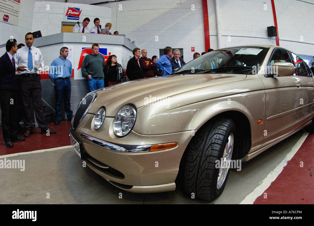 Champagne coloured Jaguar SType car being sold at a car auction, UK