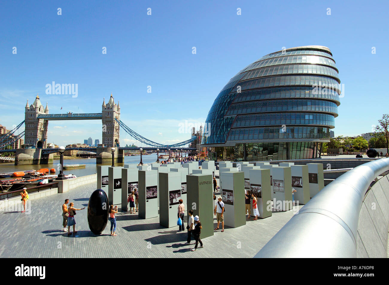 A wide angle view of the Thames with City Hall and Tower Bridge against a blue sky. Stock Photo
