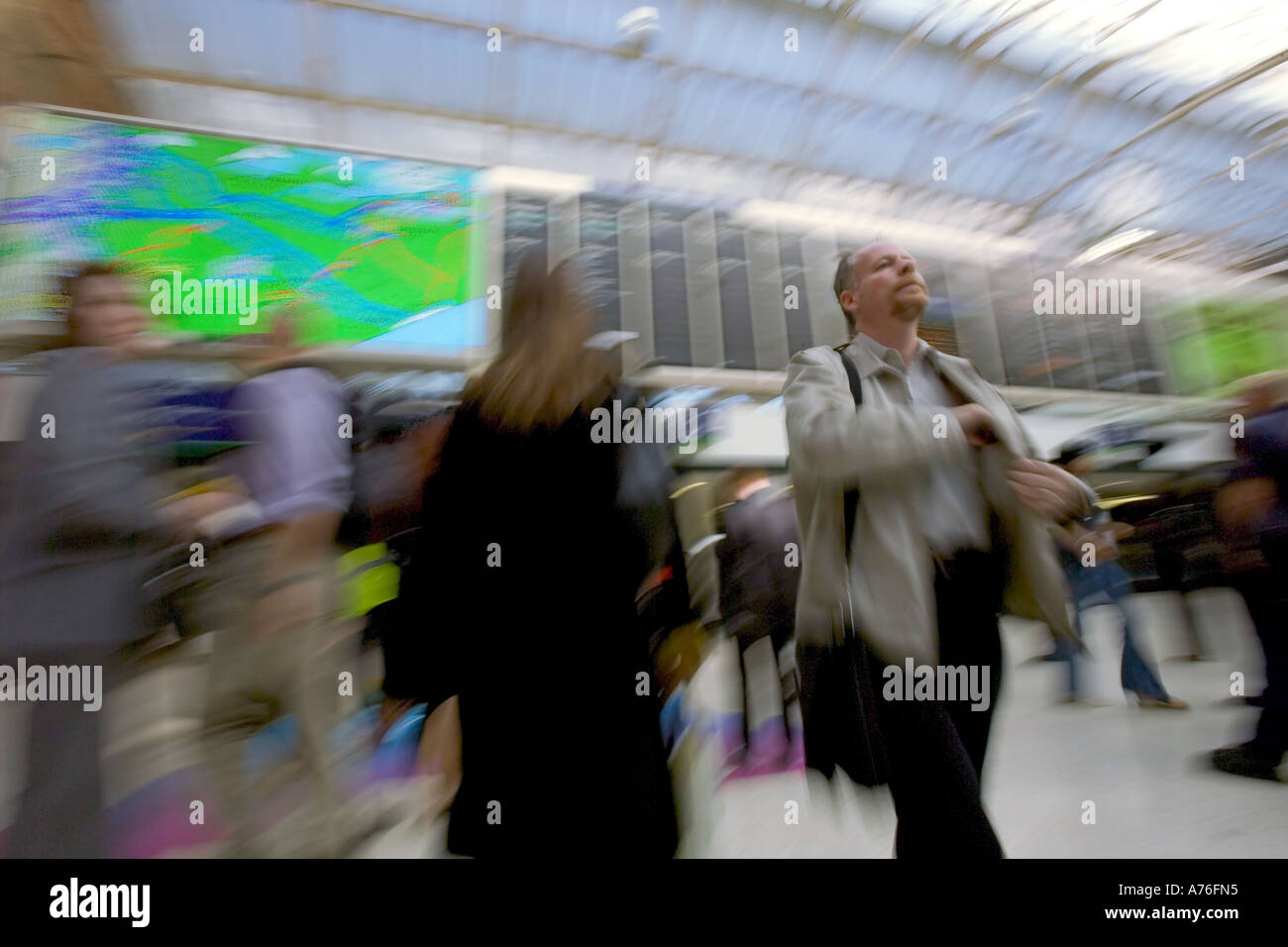 Commuters travelling through Charing Cross railway station during rush hour with motion blur