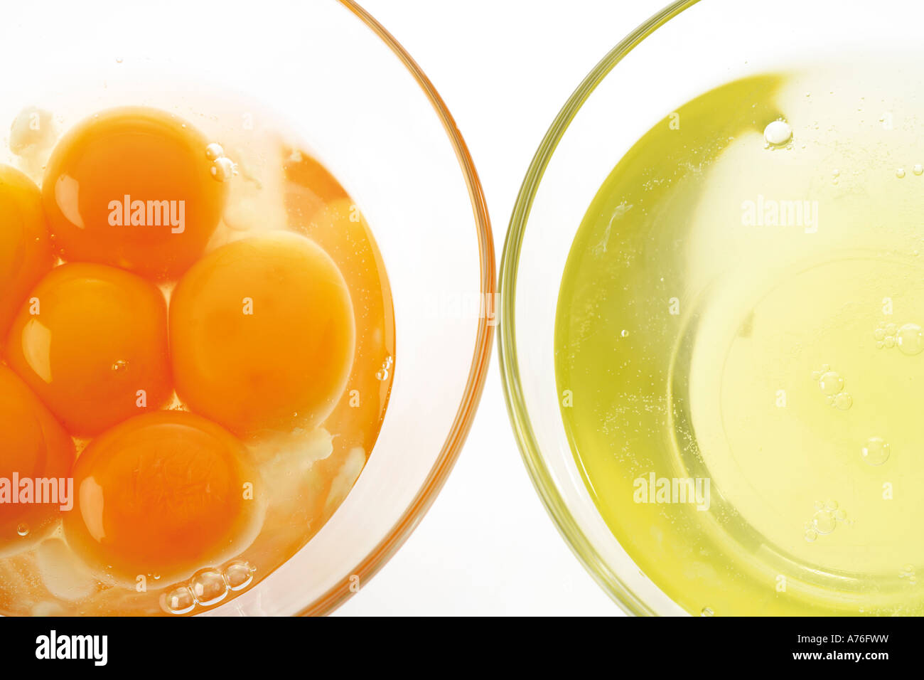 Two bowls of egg white and egg yolk, elevated view, closeup Stock