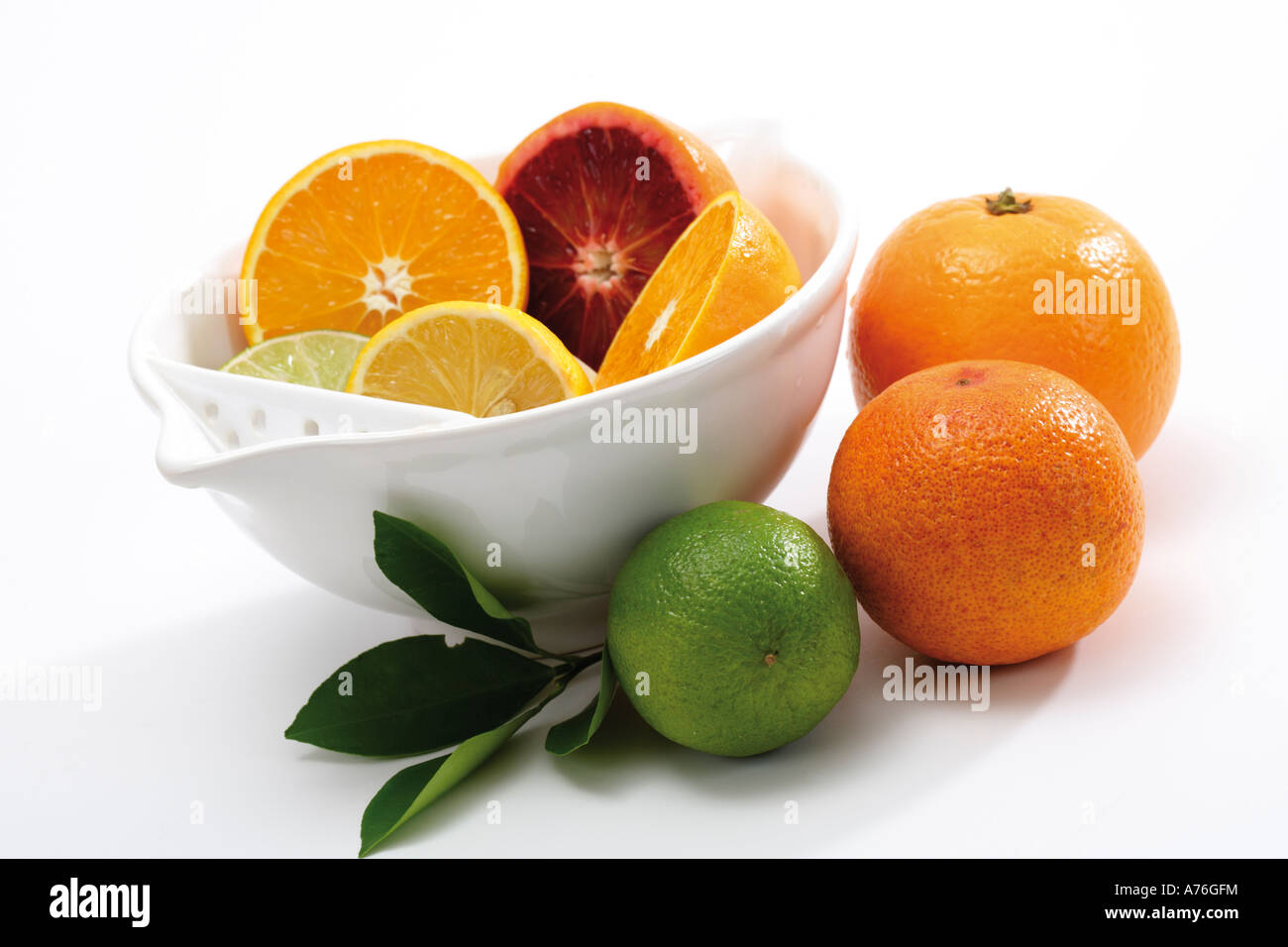 Sliced citrus fruits in bowl Stock Photo