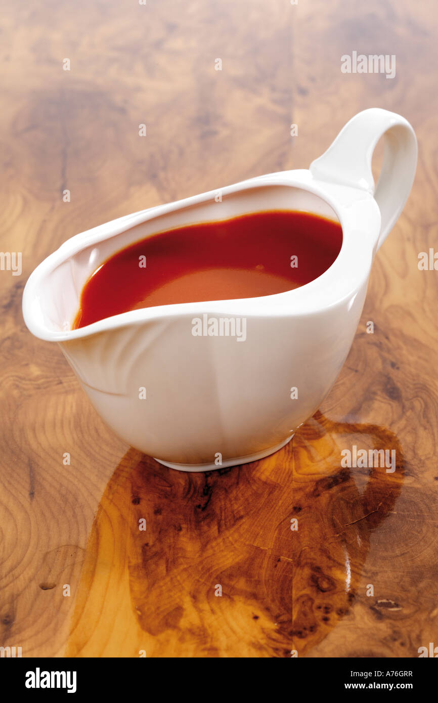 Sauce boat with tomato sauce Stock Photo