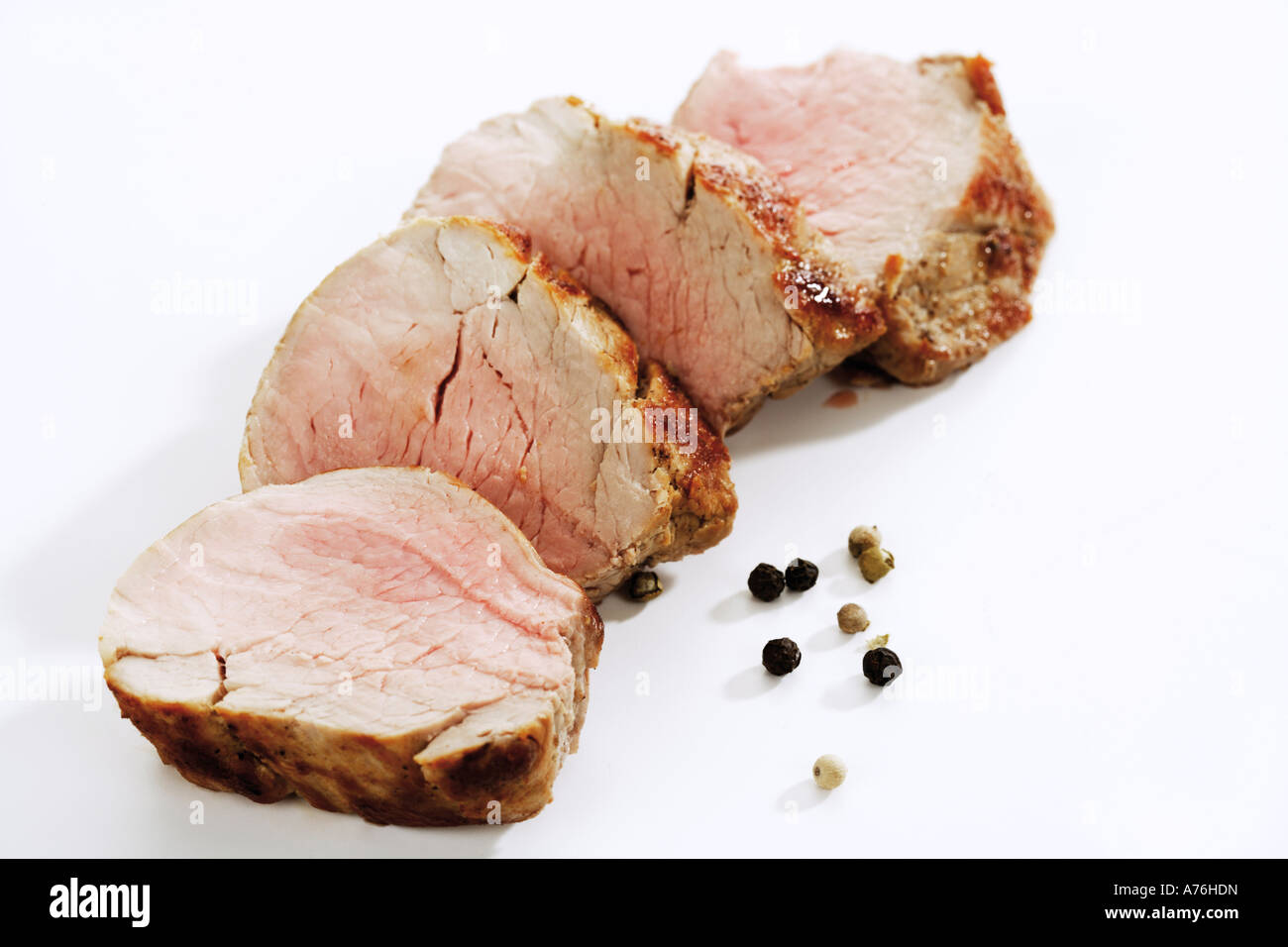Roasted pork filet, slices, spice grains, closeup Stock Photo Alamy