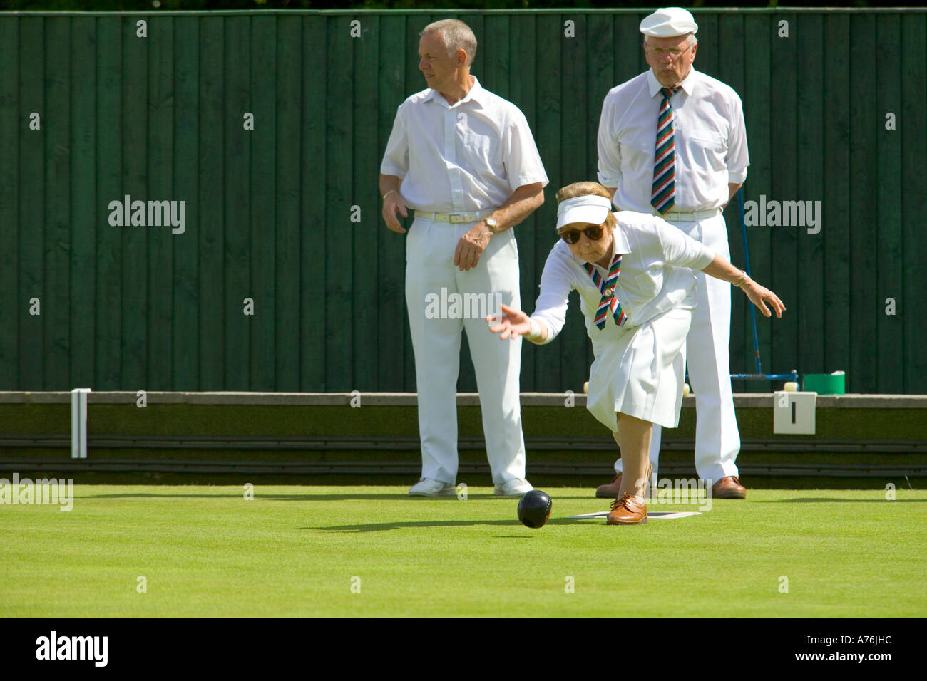 A view of the green with a female team member about to bowl. Stock Photo